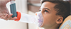Boy with inhaler with an extender
